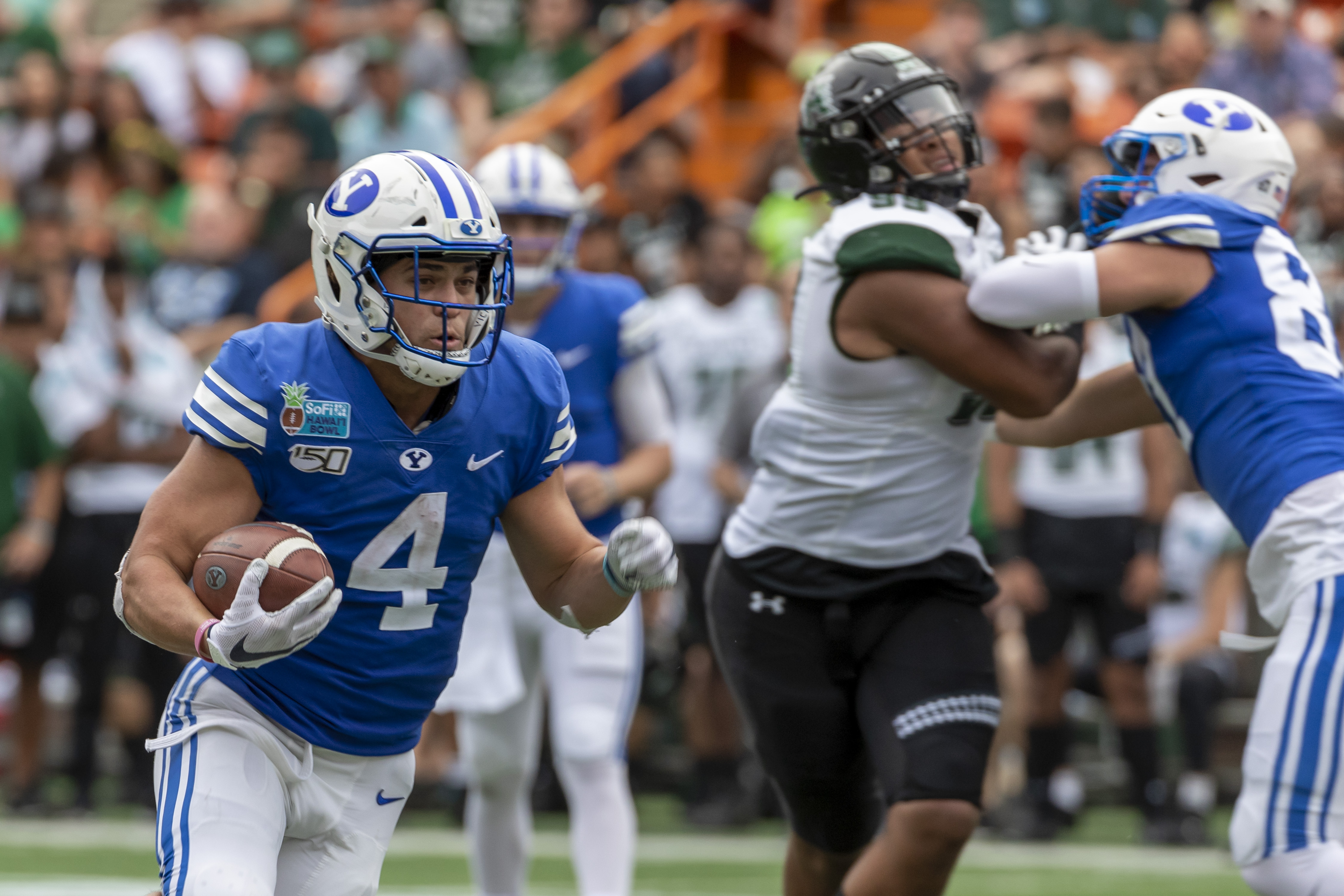 BYU running back Lopini Katoa (4) runs with the football during the first half of the team's Hawaii Bowl NCAA college football game against Hawaii, Tuesday, Dec. 24, 2019, in Honolulu. (AP Photo/Eugene Tanner)