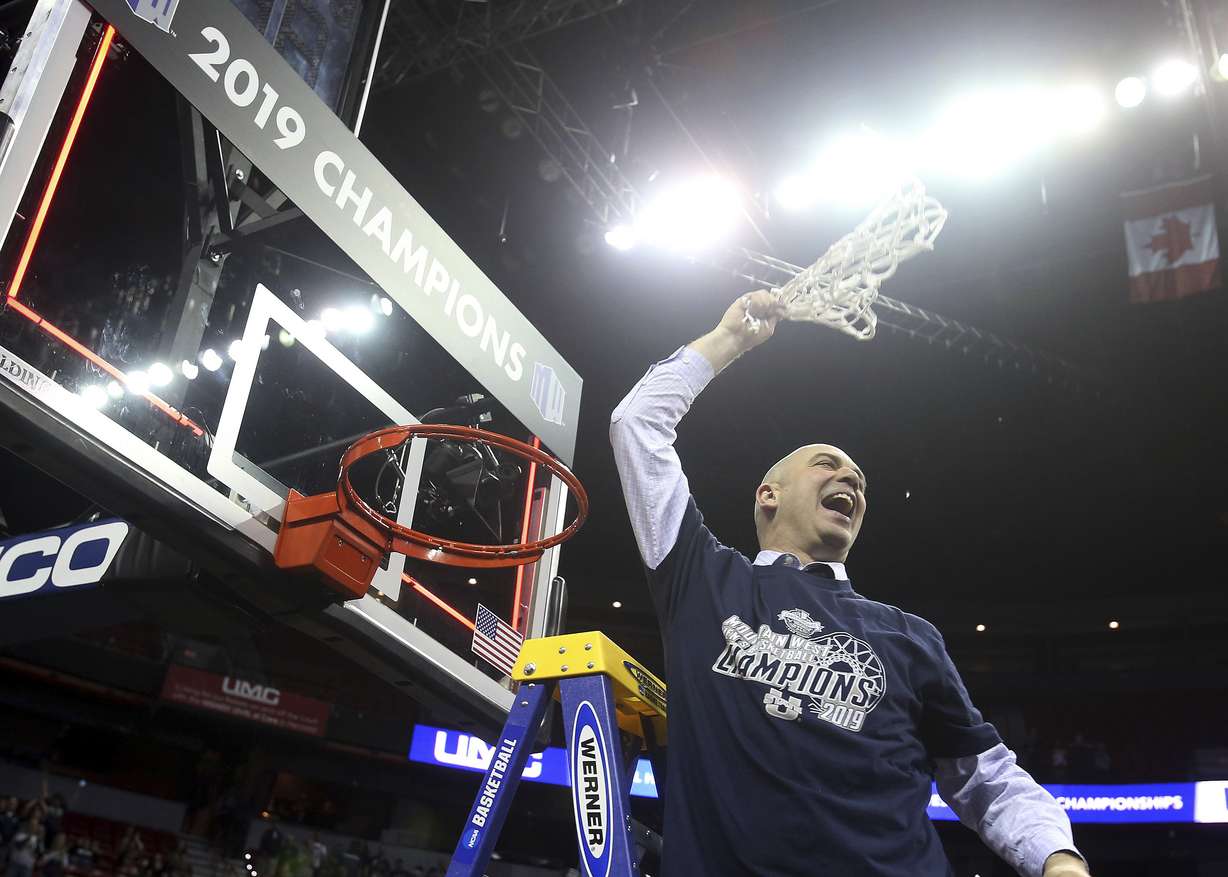 Utah State's head coach Craig Smith swings the net after defeating San Diego State in an NCAA college basketball game in the Mountain West Conference men's tournament championship Saturday, March 16, 2019, in Las Vegas. (AP Photo/Isaac Brekken)