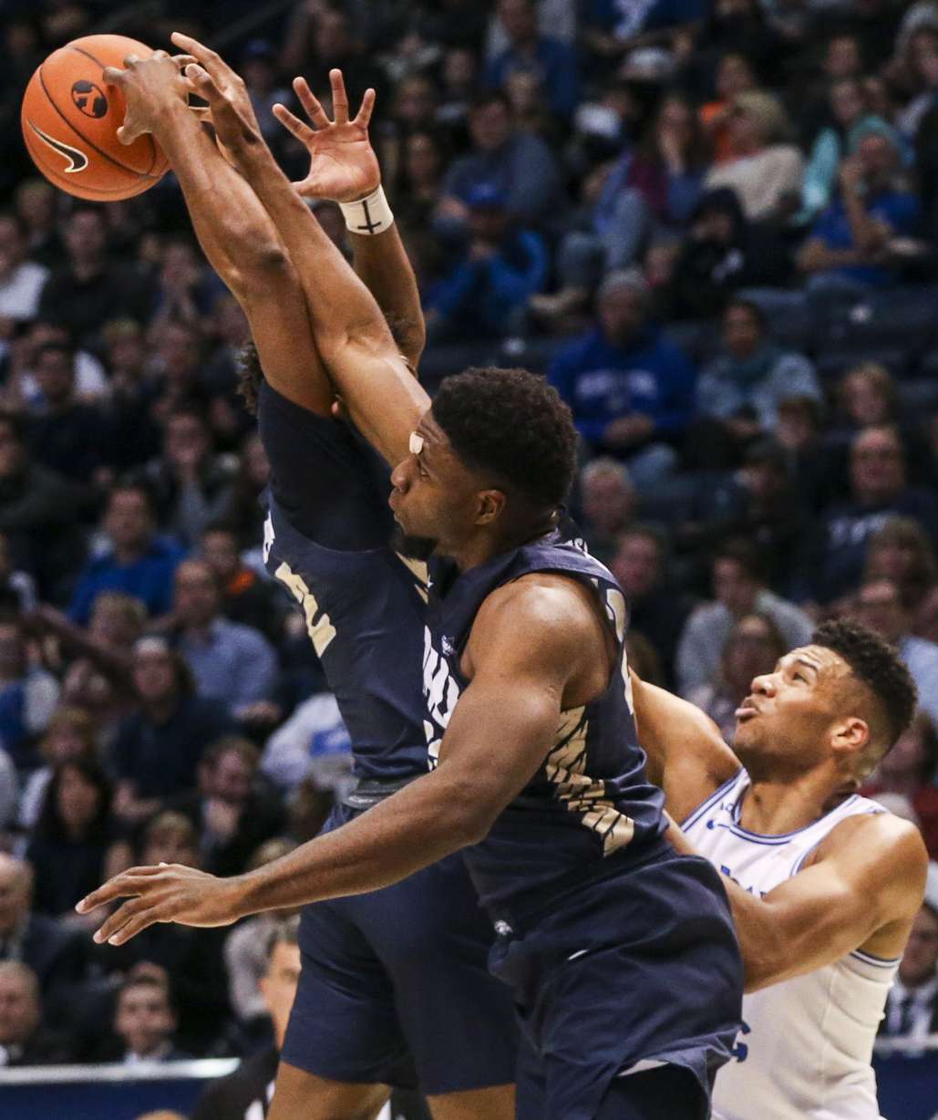 Oral Roberts Golden Eagles guard Deondre Burns (2), back left, and forward Emmanuel Nzekwesi (23) fight each other for a rebound while Brigham Young Cougars forward Yoeli Childs (23) watches during the first half of an NCAA men's basketball game at the Marriott Center in Provo on Saturday, Dec. 28, 2019. (Photo: Colter Peterson, KSL)