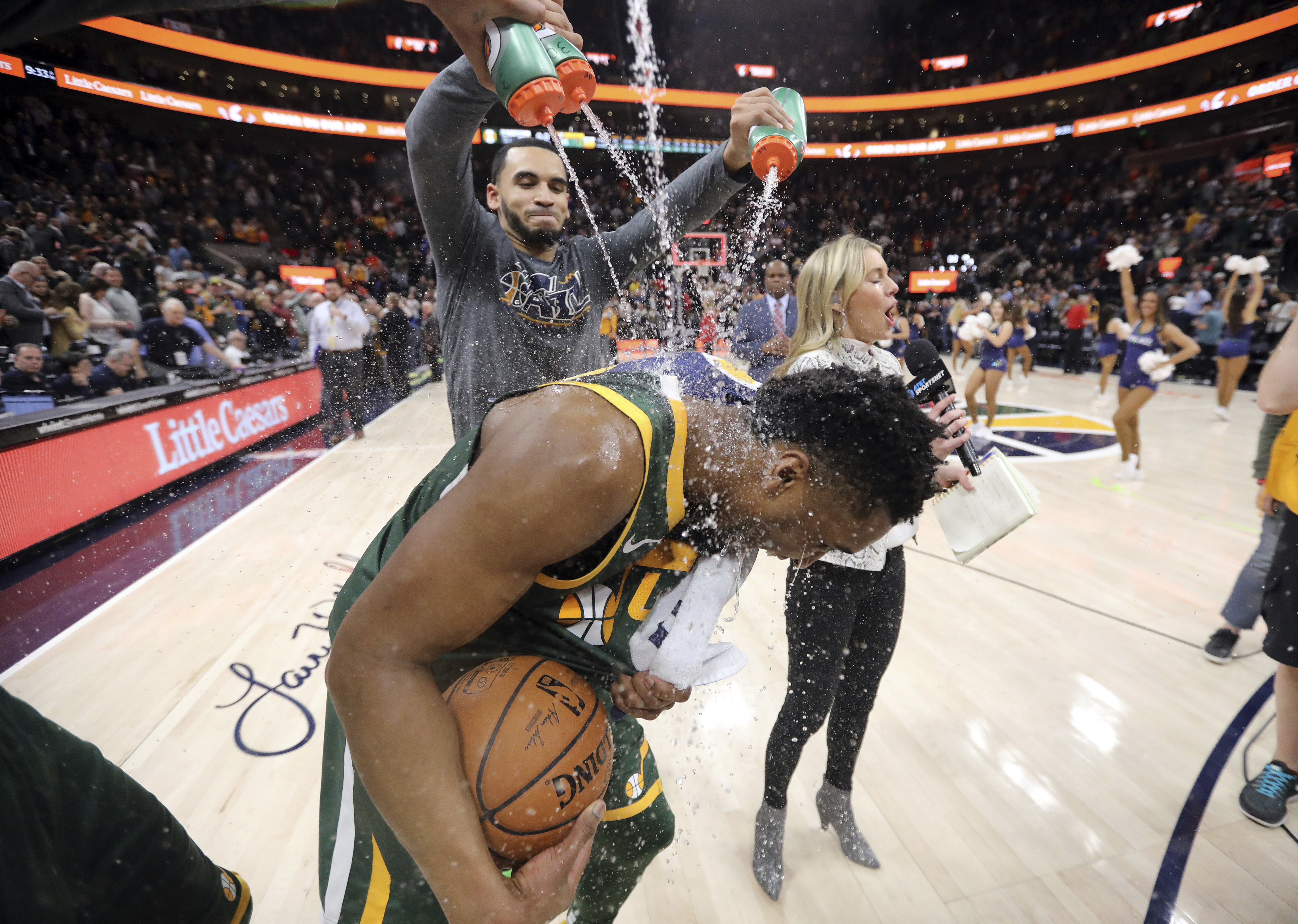 Utah Jazz guard Naz Mitrou-Long, rear, soaks guard Donovan Mitchell following the team's NBA basketball game against the Milwaukee Bucks on Saturday, March 2, 2019, in Salt Lake City. (AP Photo/Rick Bowmer)