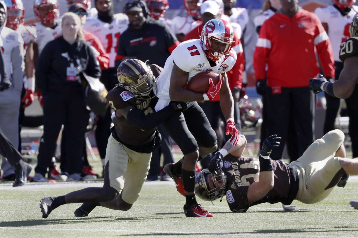 Western Kentucky wide receiver Lucky Jackson (11) is tackled by Western Michigan cornerback Anton Curtis (3) after a reception during the first half of the NCAA First Responder Bowl college football game in Dallas, Monday, Dec. 30, 2019. (AP Photo/Roger Steinman)