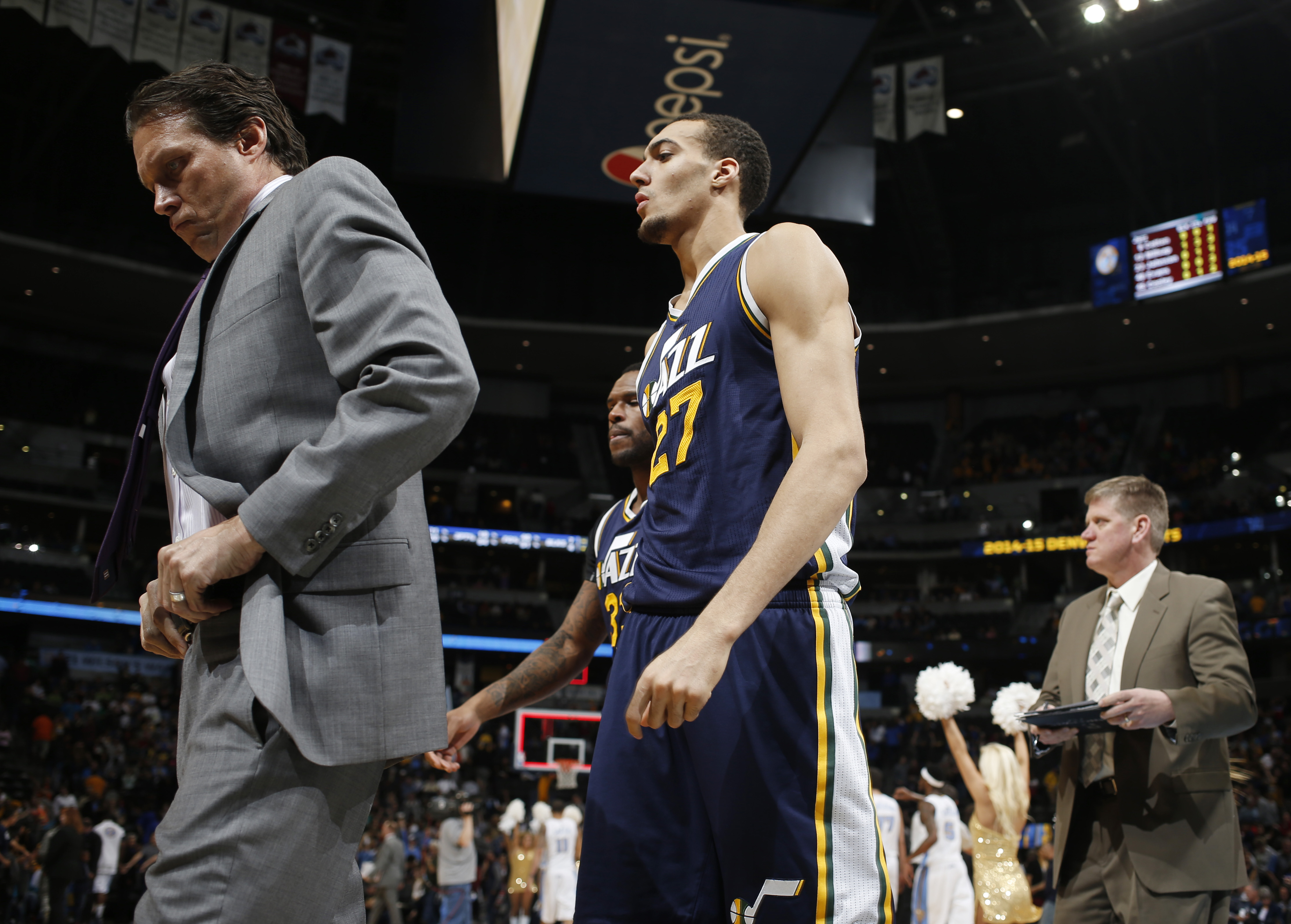 Utah Jazz head coach Quin Snyder, left, walks off the court with center Rudy Gobert, of France following a game on Friday, March 27, 2015, in Denver. (AP Photo/David Zalubowski)