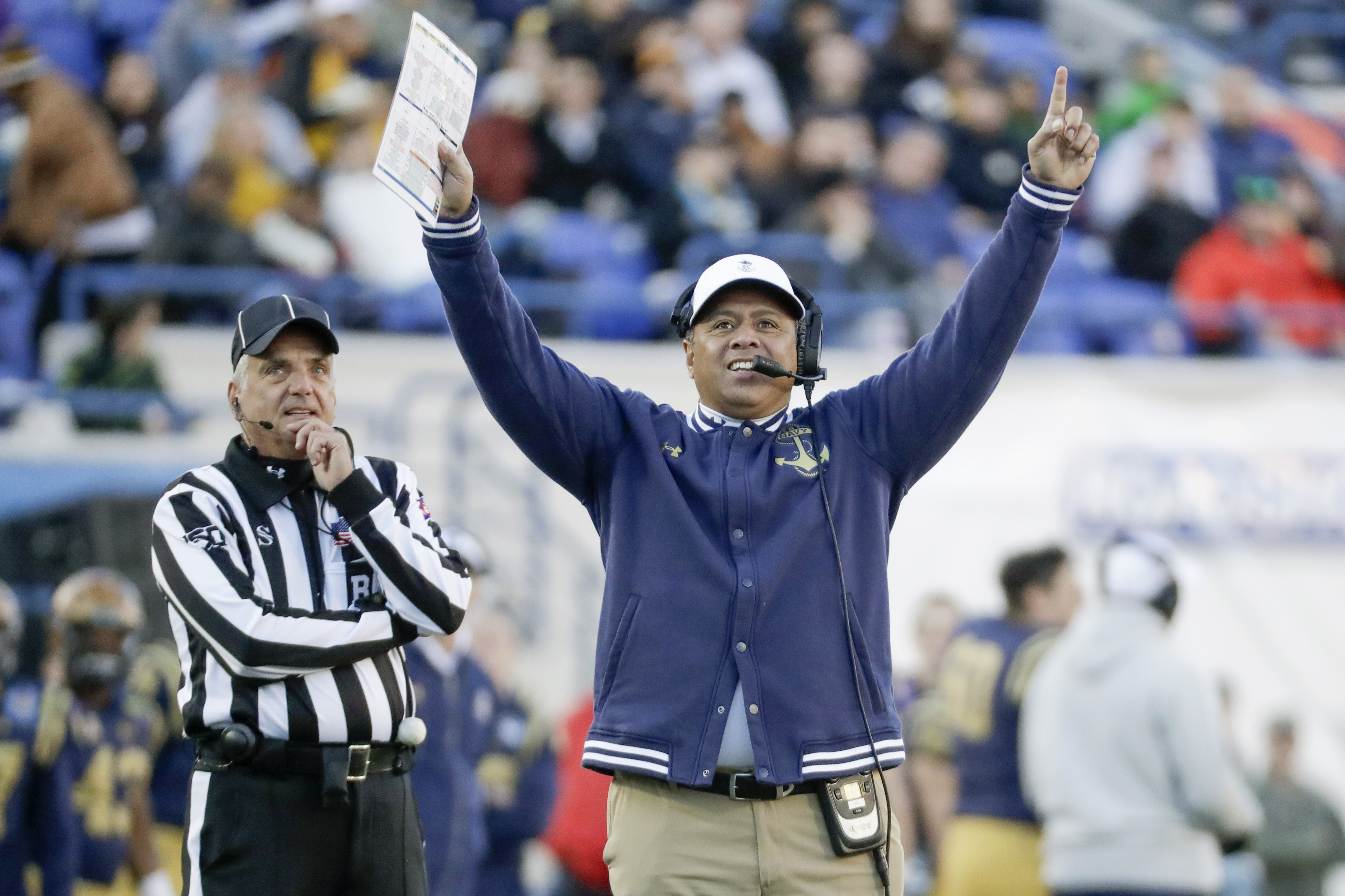 Navy head coach Ken Niumatalolo watches a replay in the first half of the Liberty Bowl NCAA college football game between Navy and Kansas State Tuesday, Dec. 31, 2019, in Memphis, Tenn.