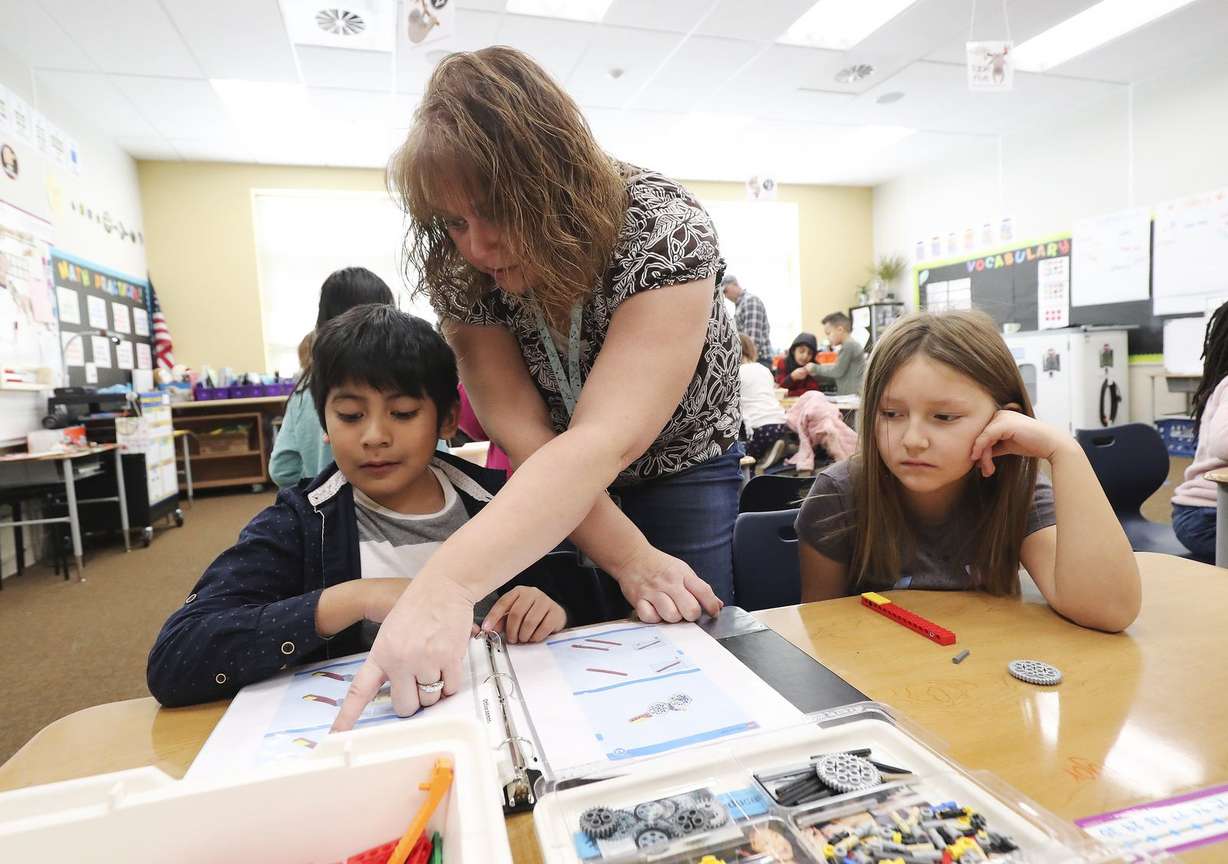 STEM teacher Debora Johnson works on a Lego engineering activity with Midvale Elementary School students Manny and Jyora at the Midvale school on Wednesday, Dec. 18, 2019. (Photo: Jeffrey D. Allred, KSL, File)