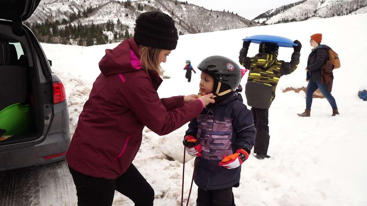 Alicia Hodges makes sure each of her four children are wearing a helmet before they go sledding. (Photo: KSL TV)