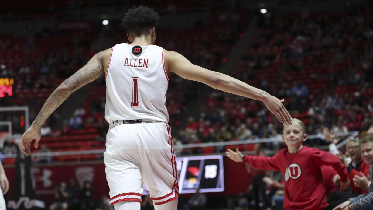 Utah Utes forward Timmy Allen (1) high-fives a fan during a game against the Oregon State Beavers in Salt Lake City on Thursday, Jan. 2, 2020.