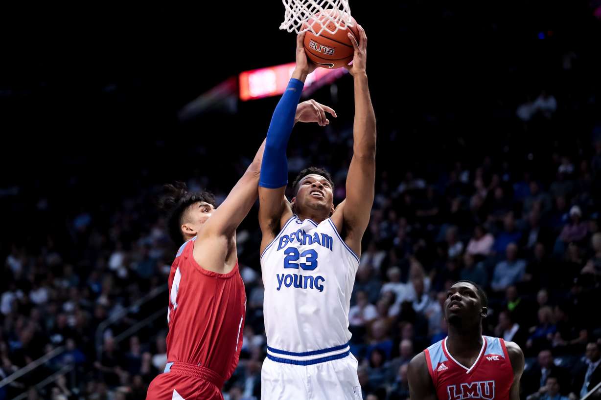 Brigham Young Cougars forward Yoeli Childs (23) goes to the hoop ahead of Loyola Marymount Lions forward Keli Leaupepe (34) during the game at the Marriott Center in Provo on Saturday, Jan. 4, 2020. (Photo: Spenser Heaps, KSL)
