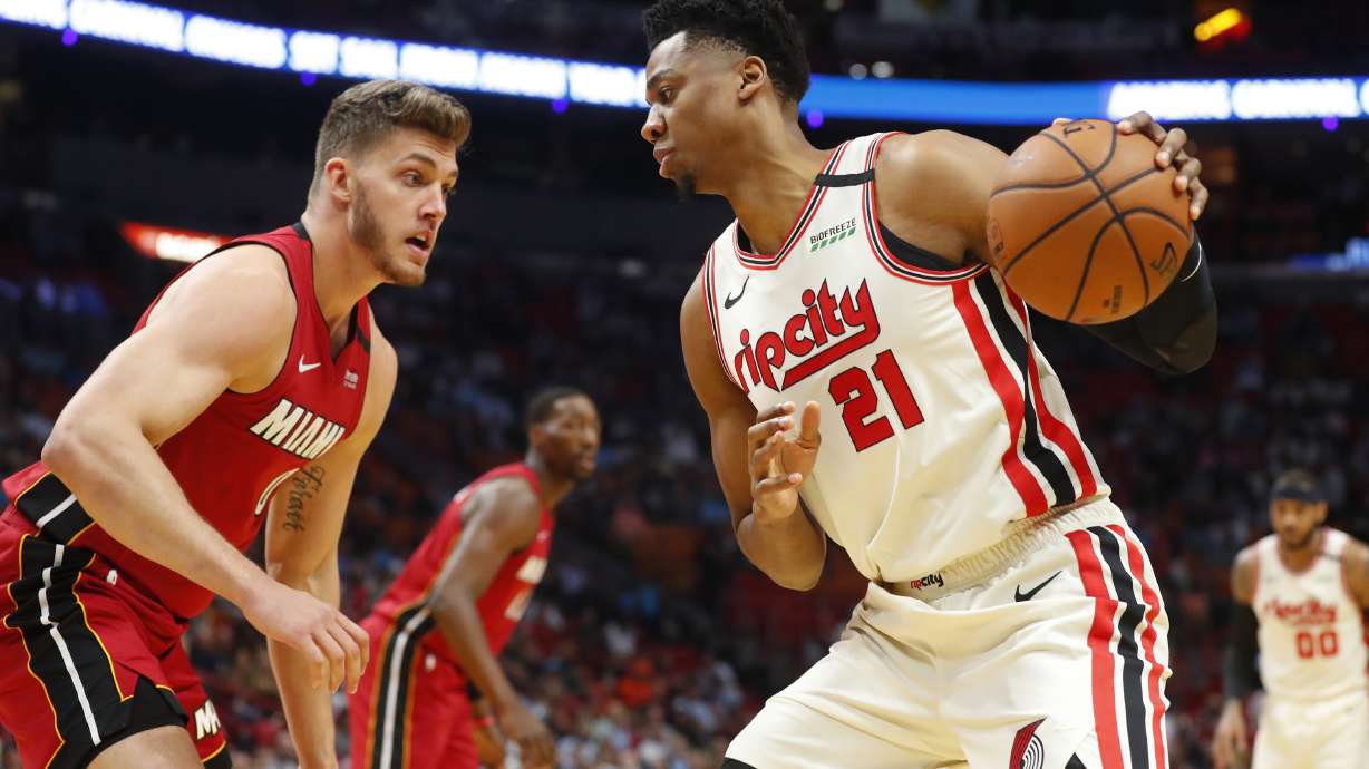 Portland Trail Blazers center Hassan Whiteside (21) drives up against Miami Heat forward Meyers Leonard (0) during the first half of an NBA basketball game, Sunday, Jan. 5, 2020, in Miami.