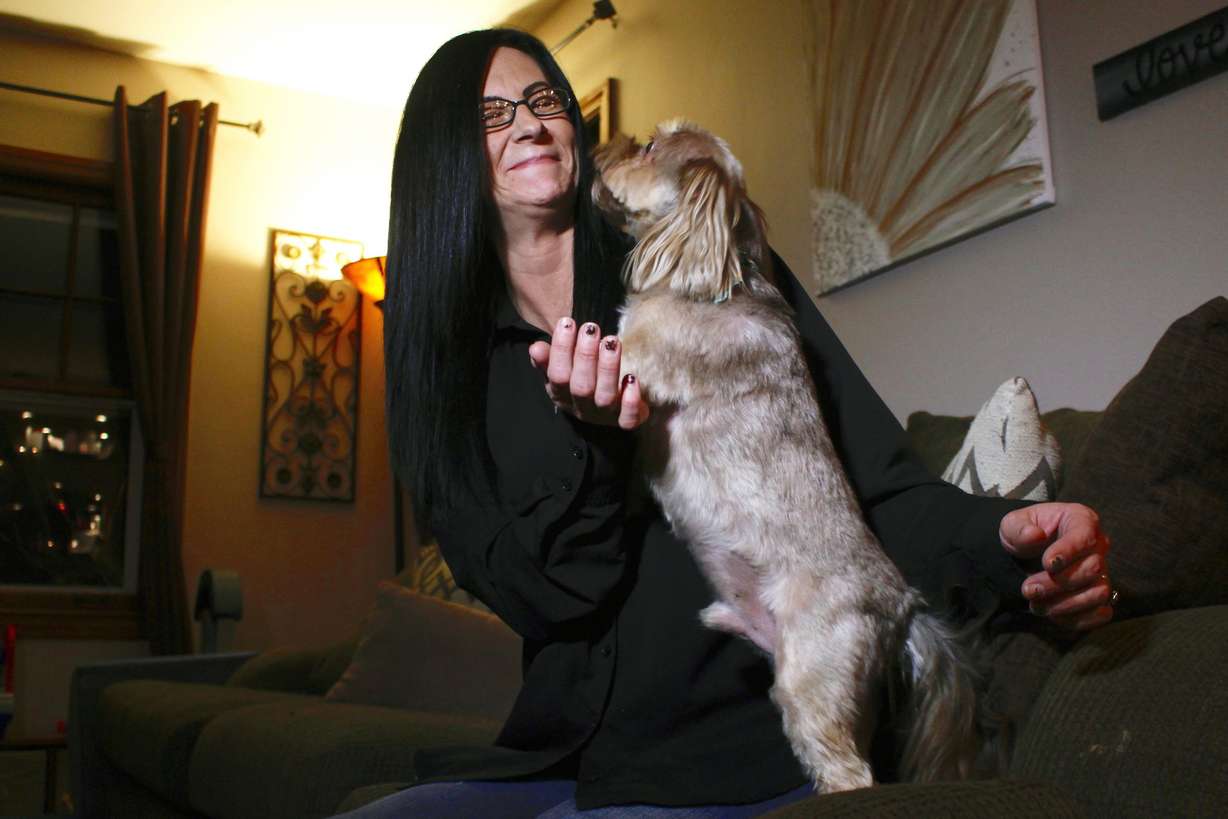 In this Nov. 5, 2019 photo, Amy Carter lets her dog Bentley lick her face at her home in St. Francis, Wis. Carter gives him CBD, which she says has reduced his epilepsy-related seizures. Photo: Carrie Antifinger, AP Photo