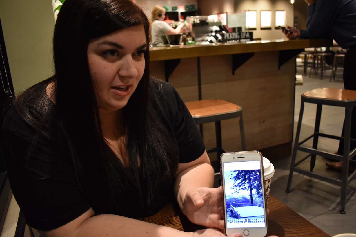 In this Thursday, Nov. 21, 2019, photo, Kelsey Norton shows pictures of her property before it was overrun by a wildfire that incinerated her house and killed 85 of her fellow townspeople in Chico, Calif. Norton says she's suffered repeated respiratory infections since breathing in smoke from the fire that destroyed her hometown of Paradise. (AP Photo/Matthew Brown)