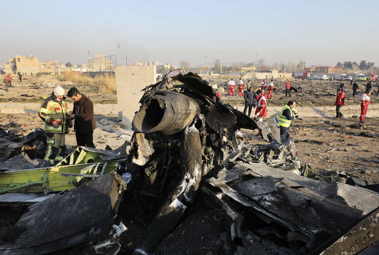FILE - In this Wednesday, Jan. 8, 2020 file photo debris at the scene where a Ukrainian plane crashed in Shahedshahr southwest of the capital Tehran, Iran. Two U.S. officials said Thursday that it was “highly likely” that an Iranian anti-aircraft missile downed a Ukrainian jetliner late Tuesday, killing all 176 people on board. President Donald Trump is suggesting he believes Iran was responsible. (AP Photo/Ebrahim Noroozi)