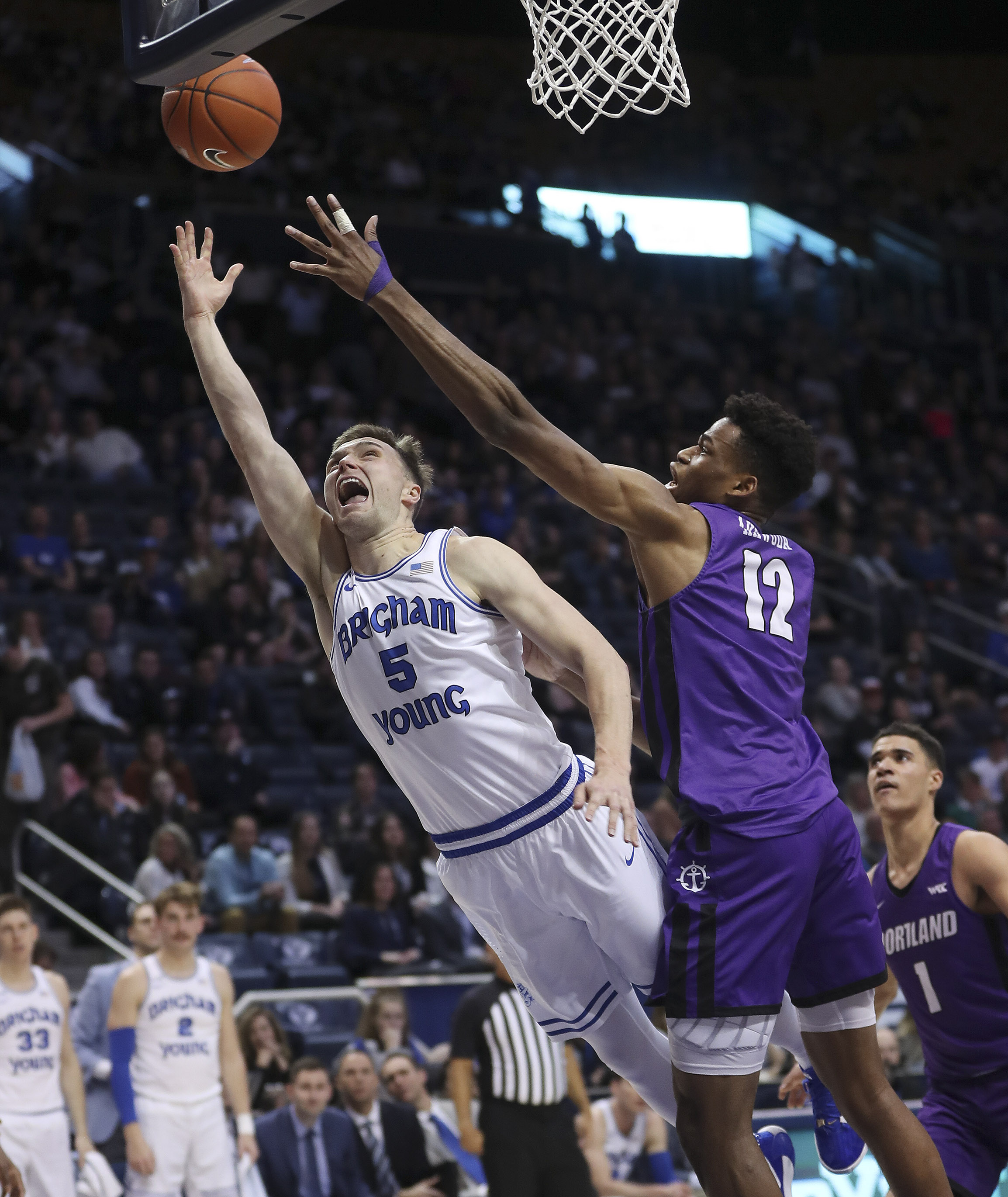 BYU Cougars guard Jake Toolson (5) drives by Portland Pilots center Theo Akwuba (12) in Provo on Saturday, Jan. 11, 2020. BYU won 96-70.(Photo: Jeffrey D. Allred, KSL)