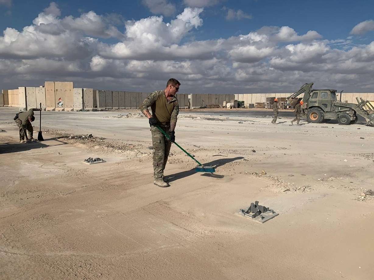 U.S. Soldiers clean up with brooms while bulldozers clear rubble and debris at Ain al-Asad air base in Anbar, Iraq, Monday, Jan. 13, 2020. Photo: Ali Abdul Hassan, AP Photo