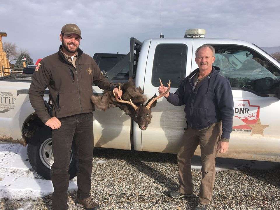 Utah Division of Wildlife Resources conservation officer Adam Wallerstein (left) and Darryl Powell (right) hold the caped portion of Coal. Coal was found dead of apparent natural causes in December and his carcass was taken to Powell's shop in Colorado to be preserved through taxidermy. (Photo courtesy Darryl Powell)