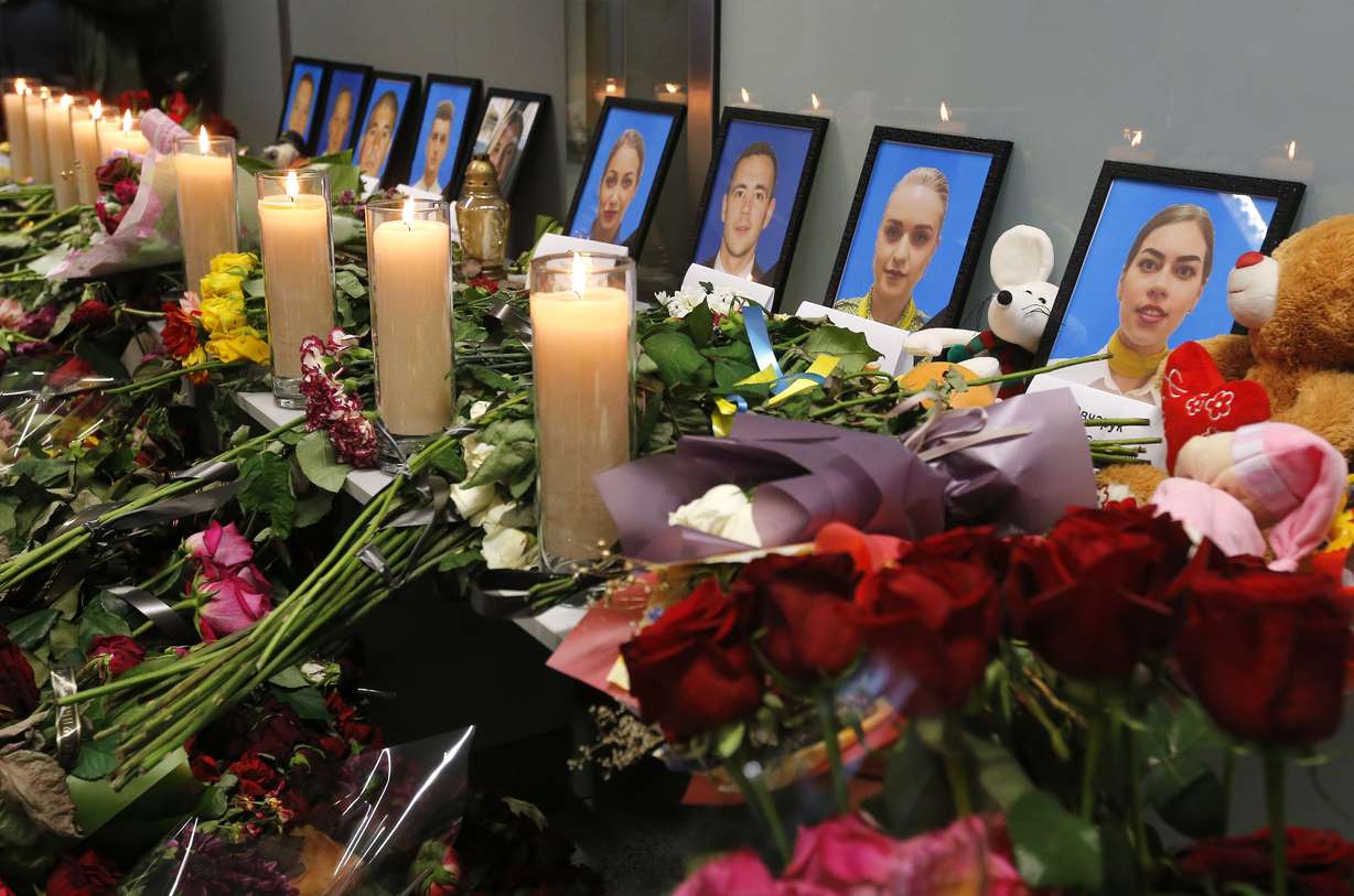 Flowers and candles are placed in front of portraits of the flight crew members of the Ukrainian 737-800 plane that crashed on the outskirts of Tehran, at a memorial inside Borispil international airport outside Kyiv, Ukraine, Saturday, Jan. 11, 2020. Photo: Efram Lukatsky, AP Photo