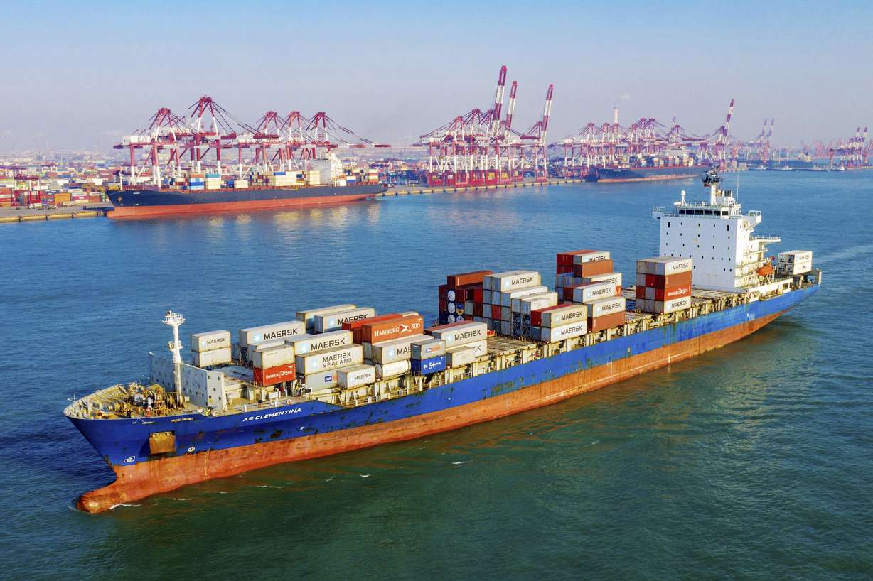 A container vessel moves past the port in Qingdao in eastern China's Shandong province on Tuesday, Jan. 14, 2020. Photo: ChinaTopix via AP