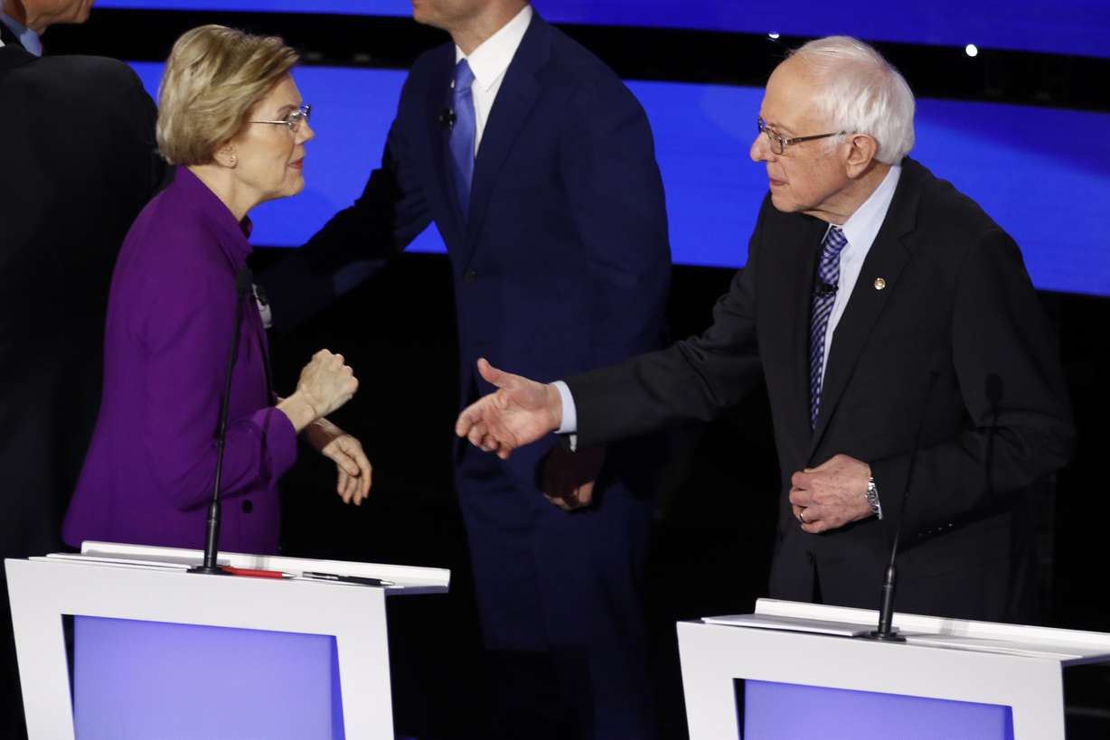 Democratic presidential candidate Sen. Elizabeth Warren, D-Mass., left and Sen. Bernie Sanders, I-Vt. talk Tuesday, Jan. 14, 2020, after a Democratic presidential primary debate hosted by CNN and the Des Moines Register in Des Moines, Iowa. (Patrick Semansky, AP Photo)