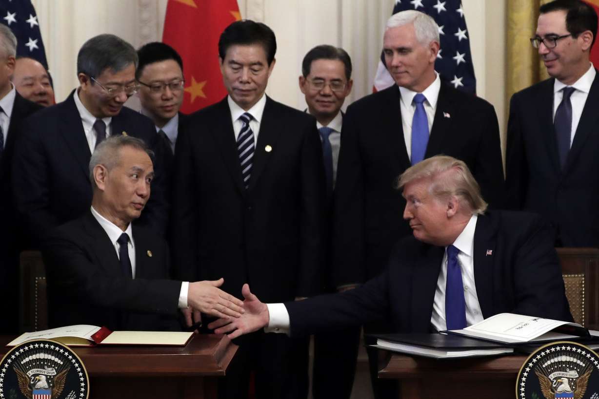 President Donald Trump shakes hands with Chinese Vice Premier Liu He, after signing a trade agreement in the East Room of the White House, Wednesday, Jan. 15, 2020, in Washington. (Evan Vucci, AP Photo)