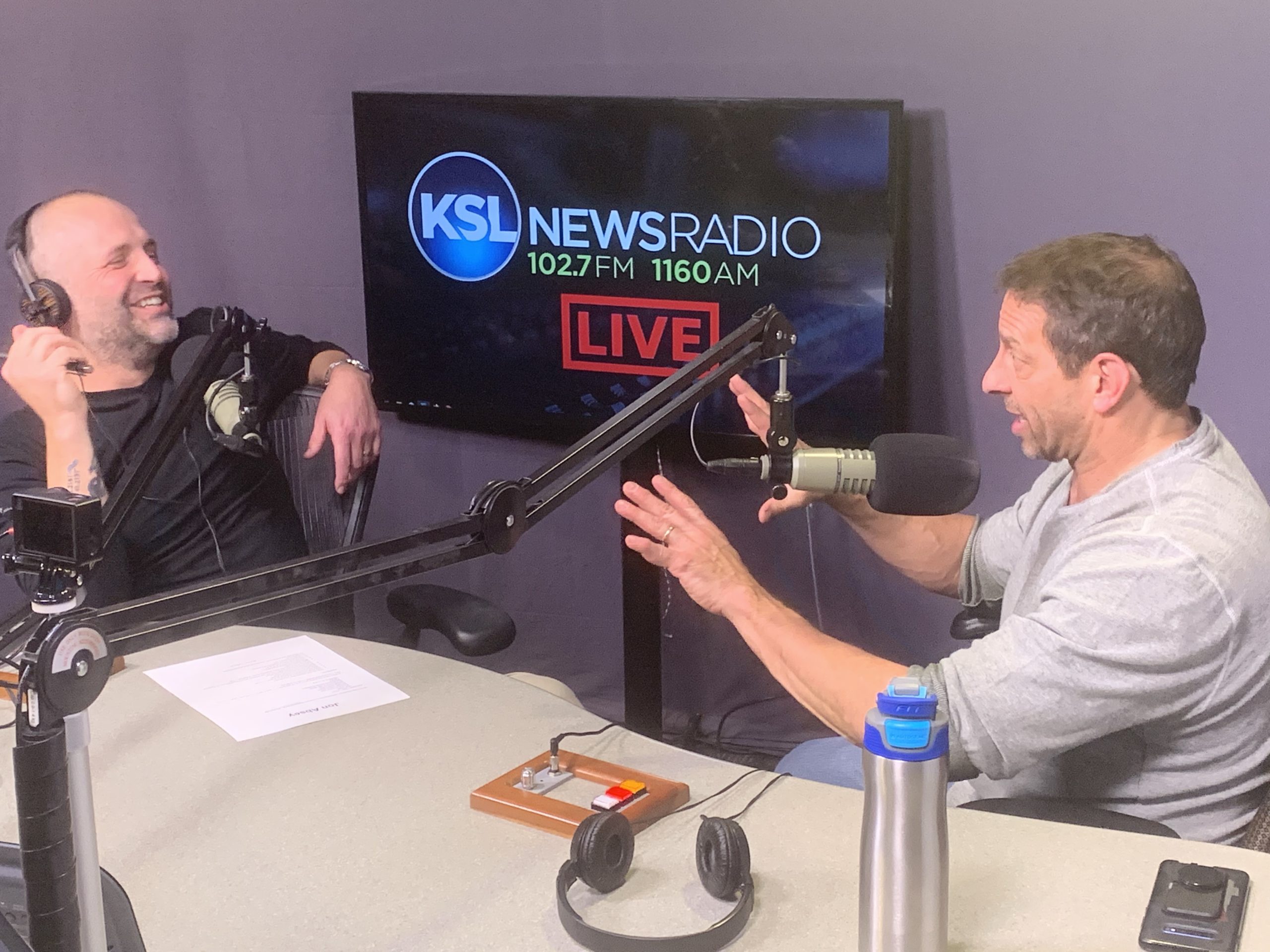 “Return to Real” host Neil Anderson laughs as former Jazz Bear Jon Absey recounts a run-in with legendary Utah basketball coach Jerry Sloan. Photo: Becky Bruce, KSL NewsRadio