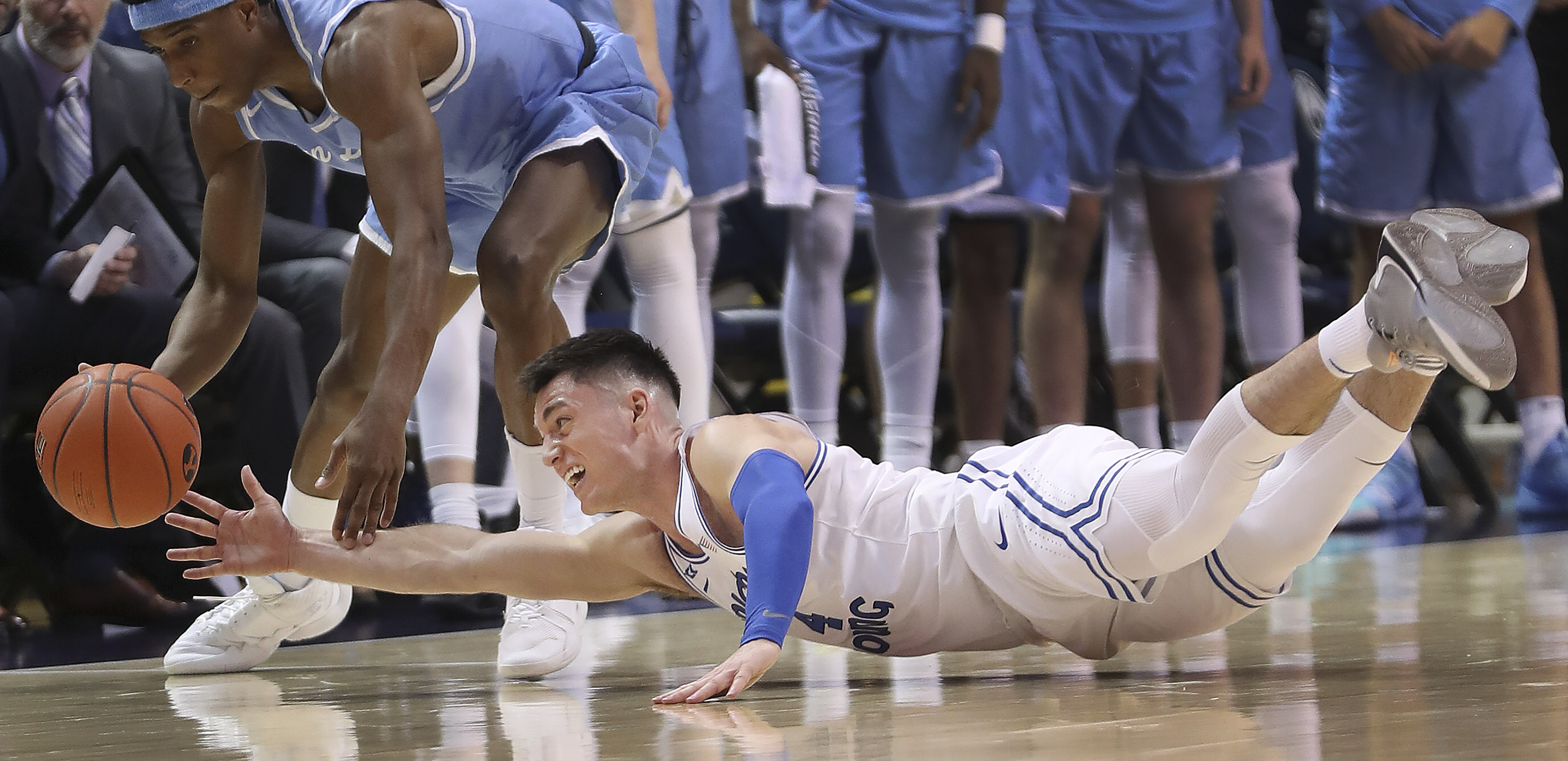 Brigham Young Cougars guard Alex Barcello (4) dives for the ball from San Diego Toreros guard Marion Humphrey (0) in Provo on Thursday, Jan. 16, 2020. BYU won 93-70. (Photo: Jeffrey D. Allred, KSL)
