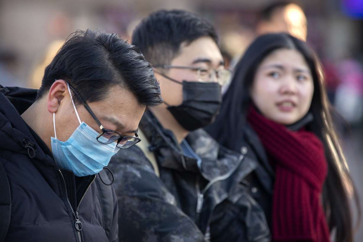Travelers wear face masks as they walk outside of the Beijing Railway Station in Beijing, Monday, Jan. 20, 2020. China reported Monday a sharp rise in the number of people infected with a new coronavirus, including the first cases in the capital. The outbreak coincides with the country's busiest travel period, as millions board trains and planes for the Lunar New Year holidays. (Photo: Mark Schiefelbein, AP)