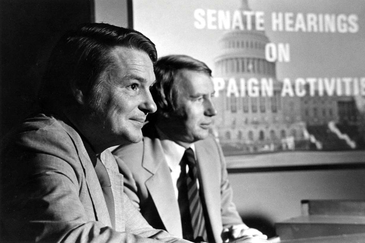 This 1973 image released by PBS shows co-anchors Jim Lehrer, left, and Robert MacNeil reporting on the Watergate hearings. PBS announced that Lehrer died Thursday, Jan. 23, 2020, at home. He was 85. (PBS via AP)