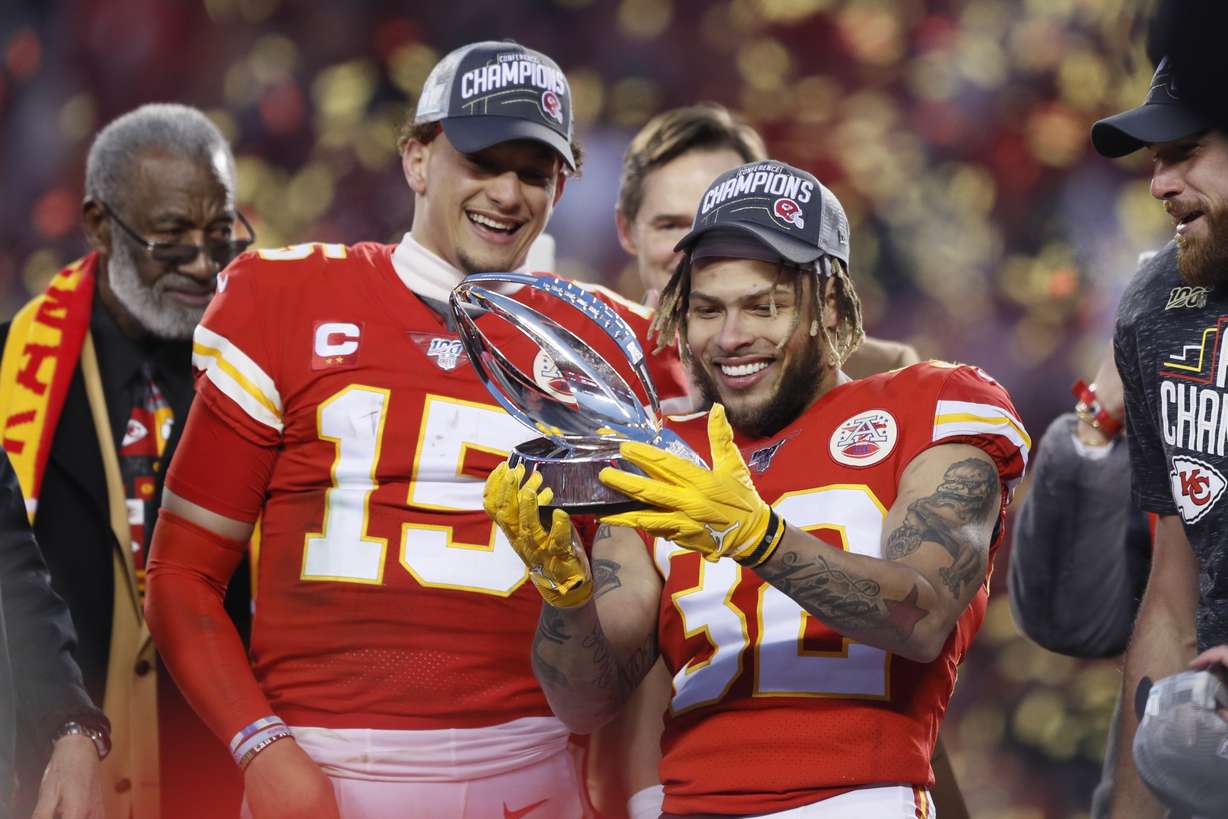 Kansas City Chiefs' Tyrann Mathieu and Patrick Mahomes (15) hold up the Lamar Hunt Trophy after the NFL AFC Championship football game against the Tennessee Titans Sunday, Jan. 19, 2020, in Kansas City, MO. The Chiefs won 35-24 to advance to Super Bowl 54. (Photo: Charlie Neibergall, AP)