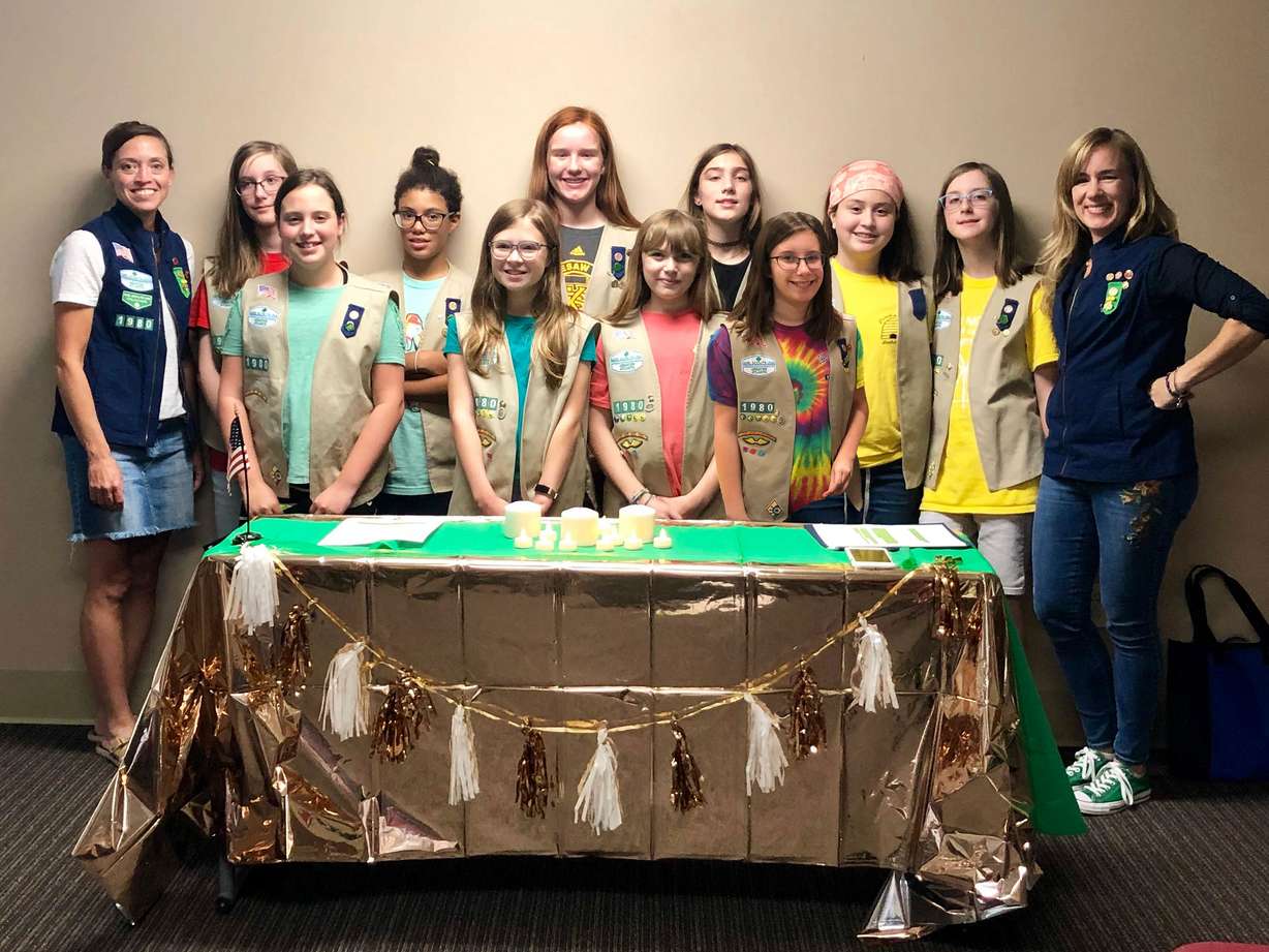 The Girl Scouts from Troop 1980 are pictured with their troop leaders Shae Evans (left) and Lisa McAbee (right). (Courtesy Lisa McAbee via CNN)