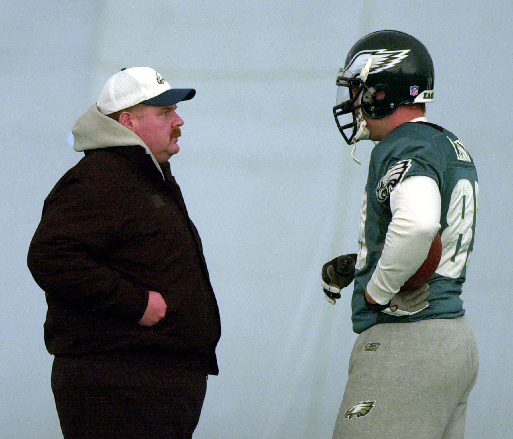 Philadelphia Eagles coach Andy Reid, left, talks with tight end Chad Lewis (89) during practice Tuesday, Jan. 8, 2002, in Philadelphia. Lewis was on hand last Sunday to watch Reid, now with the Kansas City Chiefs, clinch the franchise's first Super Bowl berth in 50 years. (Photo: Dan Loh, AP)