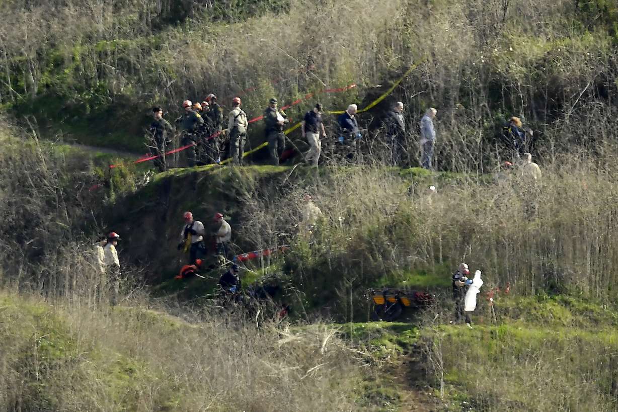 Investigators work the scene of a helicopter crash that killed former NBA basketball player Kobe Bryant, his 13-year-old daughter, Gianna, and several others Monday, Jan. 27, 2020, in Calabasas, Calif. (Mark J. Terrill, AP Photo)