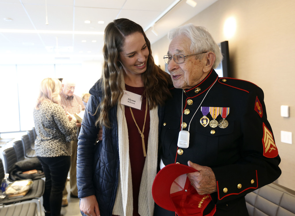 Alyssa McEwen talks to retired World War II Marine Sgt. Edgar Harrell after Harrell spoke about surviving for five days at sea after the USS Indianapolis sunk during an appearance at Goldman Sachs in Salt Lake City on Tuesday, Jan. 28, 2020. (Photo: Kristin Murphy, KSL)