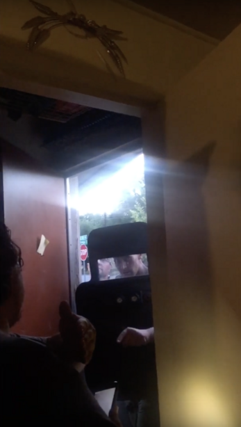 A screen grab from video provided by the ACLU of Utah shows an Adult Probation and Parole agent preparing to enter the home of the Yañez family on Aug. 20, 2018. The family has filed a lawsuit against the agency claiming agents used excessive force. American Civil Liberties Union of Utah