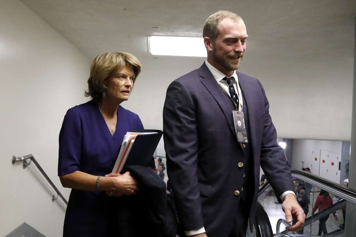Sen. Lisa Murkowski, R-Alaska, left, arrives on Capitol Hill in Washington, Thursday, Jan. 30, 2020, during the impeachment trial of President Donald Trump on charges of abuse of power and obstruction of Congress. (AP Photo/Julio Cortez)