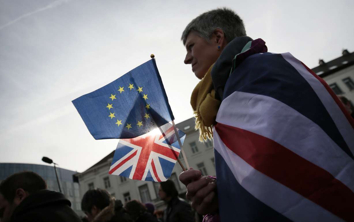 Pro-EU supporter Izzy Knowles, from Birmingham, England, wears a flag with a merger of the Union and EU flags during a ceremony to celebrate British and EU friendship outside the European Parliament in Brussels, Thursday, Jan. 30, 2020. Photo: Virginia Mayo, AP Photo