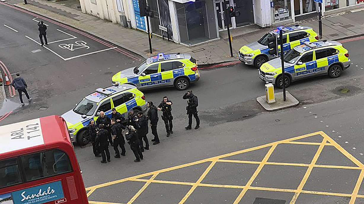 Man wearing fake bomb stabs 2 in London and is shot to death