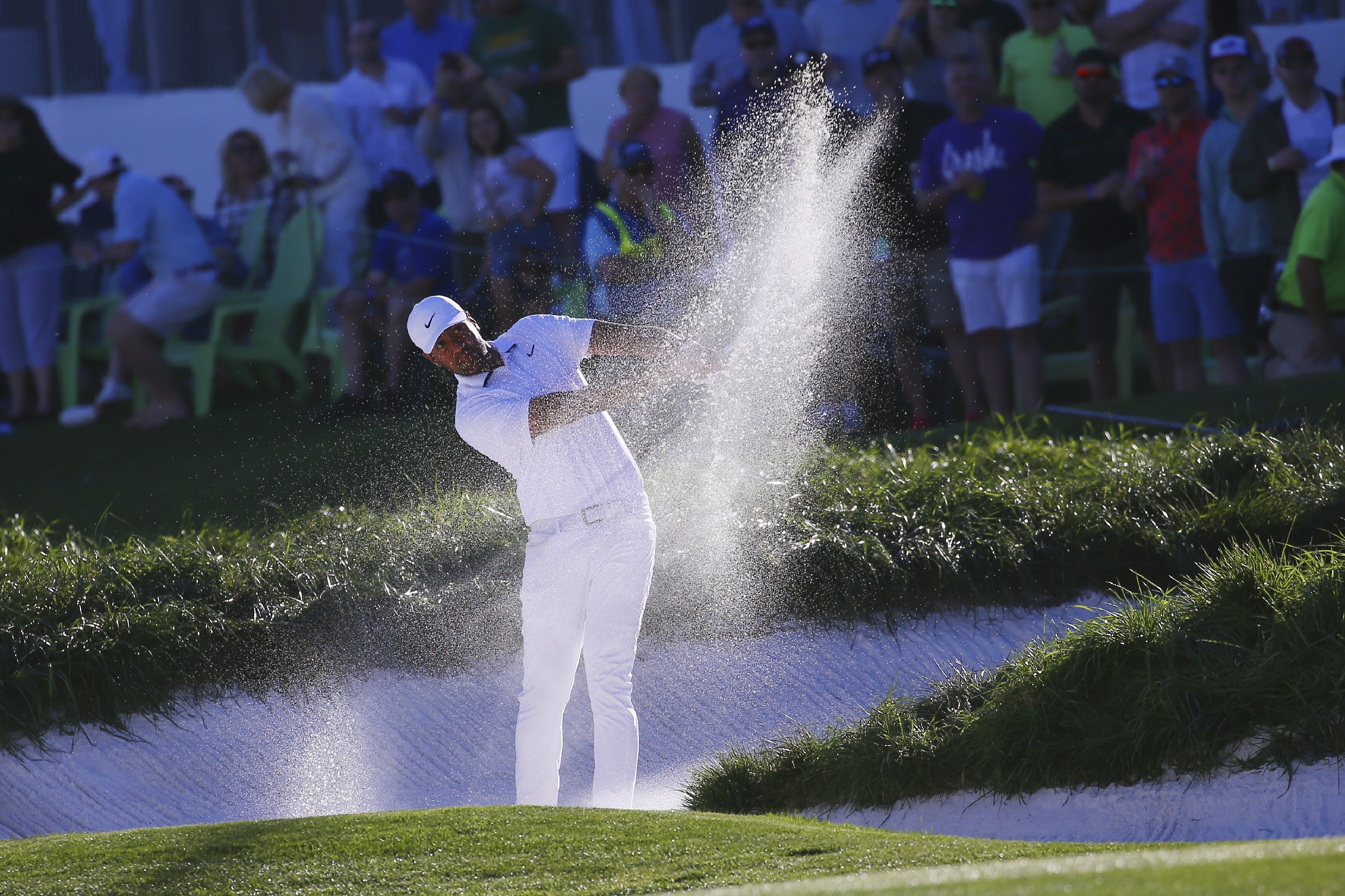 Tony Finau hits out of a fairway bunker on the first playoff hole against Webb Simpson during the final round of the Waste Management Phoenix Open PGA Tour golf event Sunday, Feb. 2, 2020, in Scottsdale, Ariz. (Photo: Ross D. Franklin, AP)