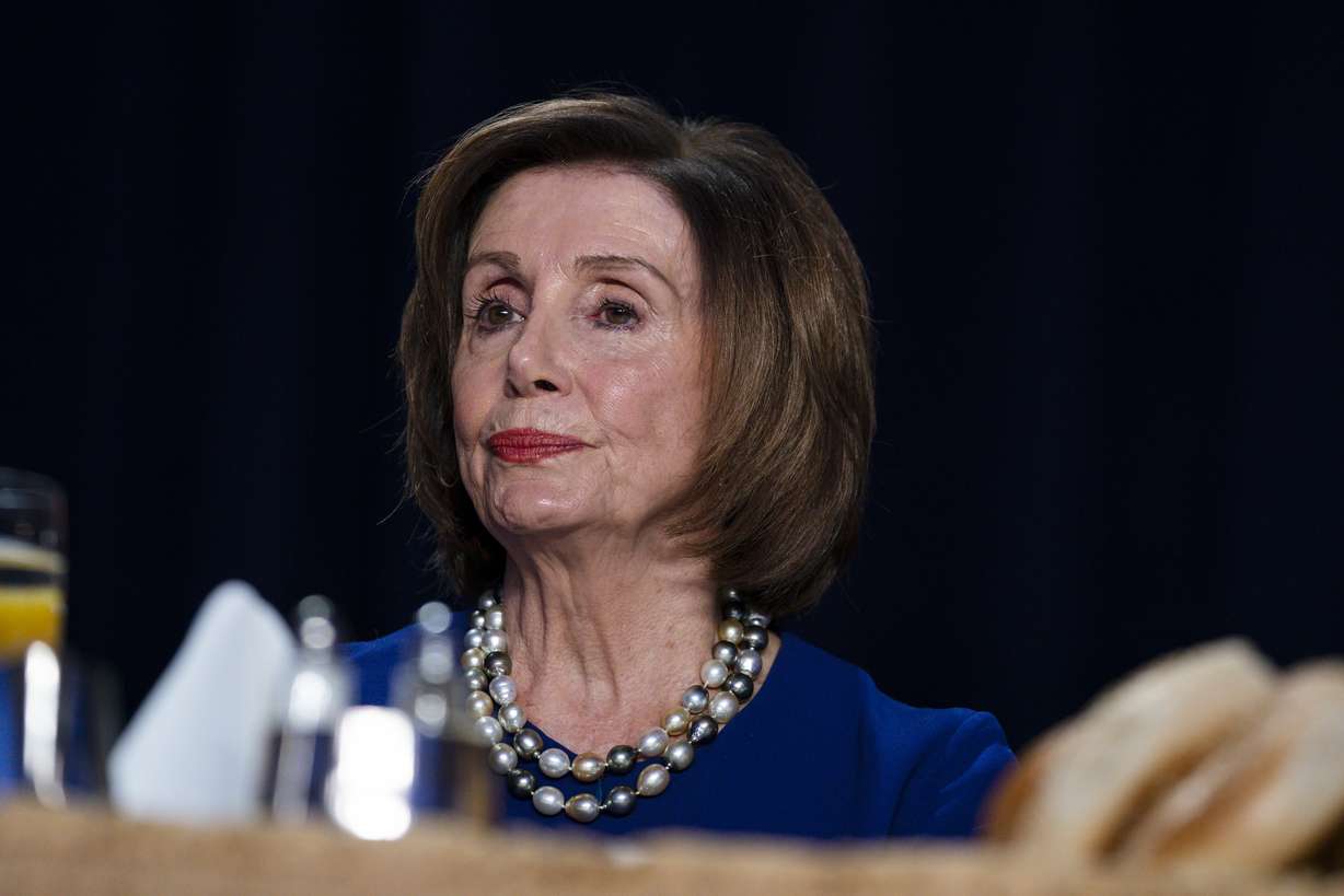 Speaker of the House Nancy Pelosi of Calif., listens as President Donald Trump speaks at the 68th annual National Prayer Breakfast, at the Washington Hilton, Thursday, Feb. 6, 2020, in Washington. (AP Photo/Evan Vucci)