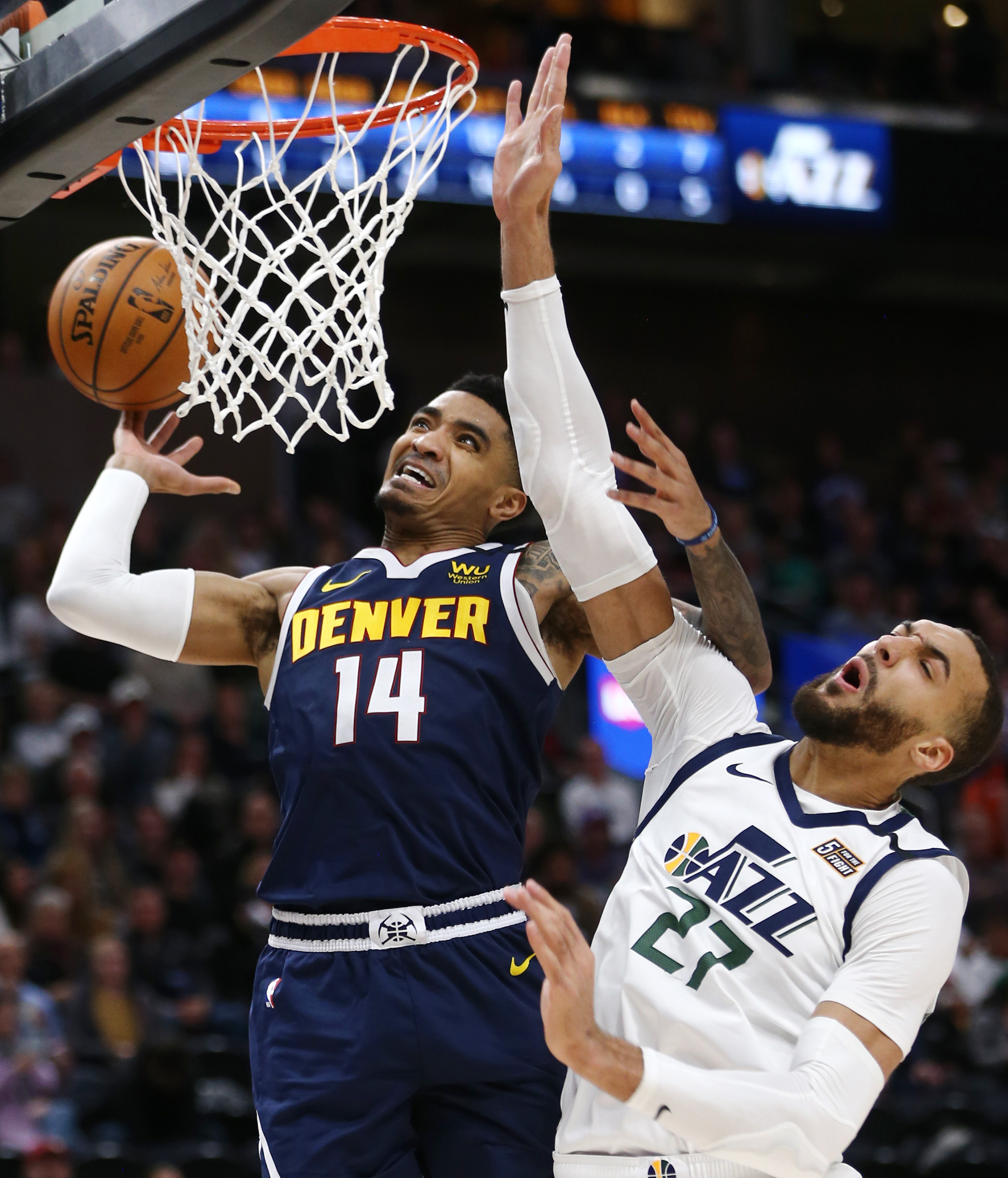 Denver Nuggets guard Gary Harris (14) loses the ball at the hoop with Utah Jazz center Rudy Gobert (27) defending as the Utah Jazz and the Denver Nuggets play an NBA basketball game at Vivint Arena in Salt Lake City on Wednesday, Feb. 5, 2020. Denver won 98-95, giving the Jazz their fifth straight loss. (Scott G Winterton, KSL)