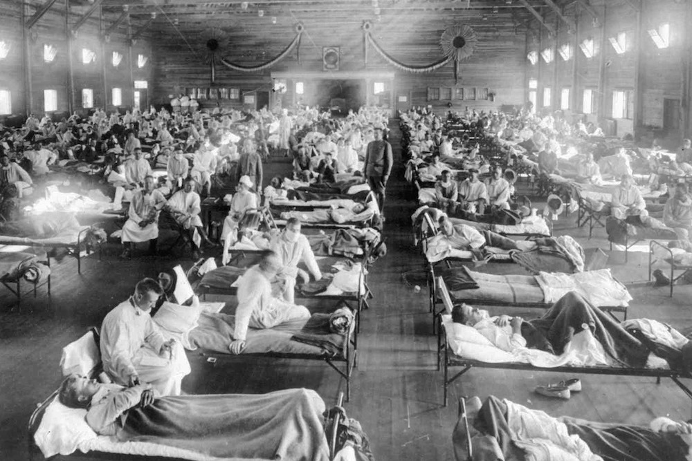 In this 1918 photograph, influenza victims crowd into an emergency hospital at Camp Funston, a subdivision of Fort Riley in Kansas. The flu, which is believed to have originated in Kansas, killed at least tens of millions of people worldwide. (National Museum of Health and Medicine, Armed Forces Institute of Pathology via AP Photo)
