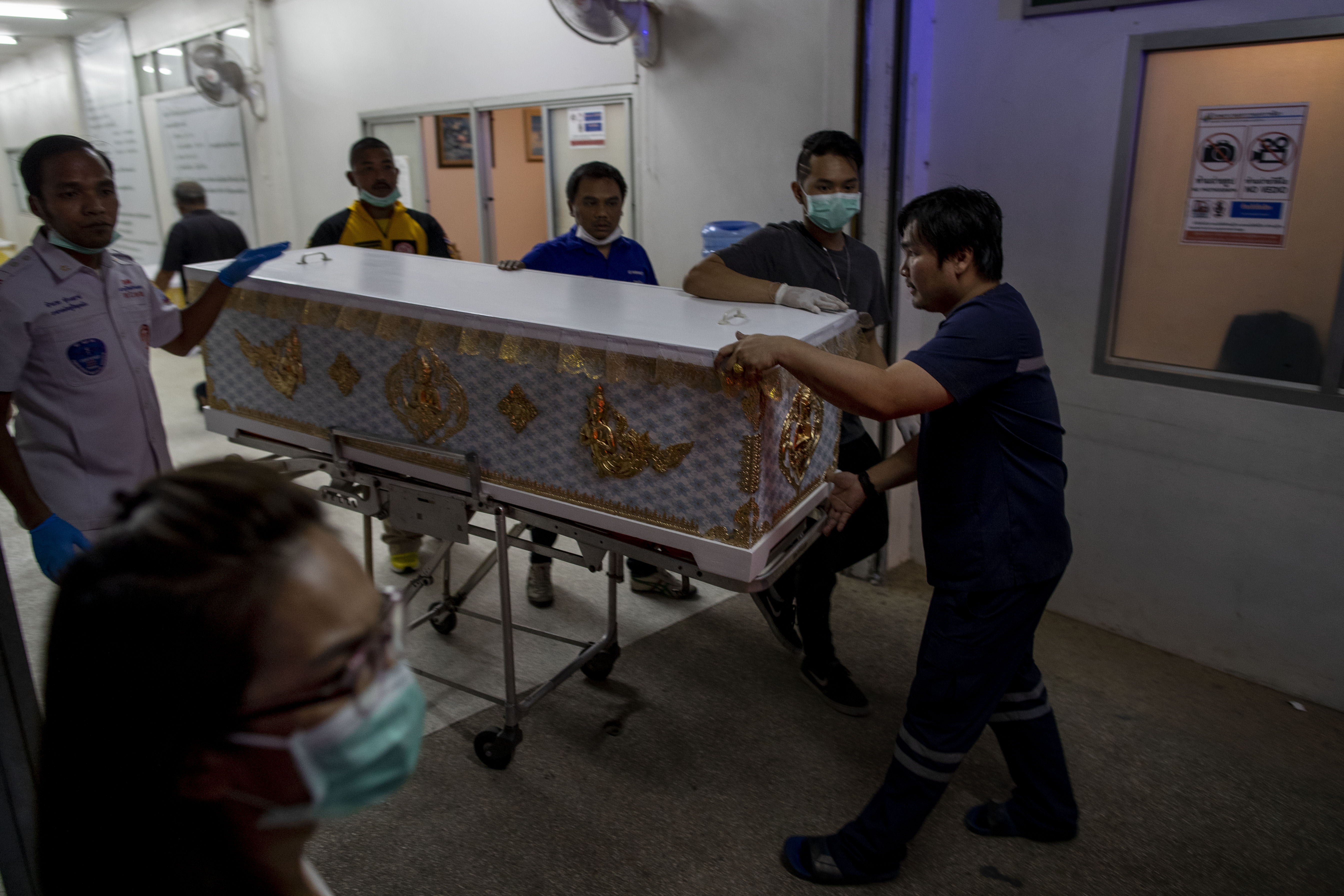 Families of Thai shooting victims wait for answers, bodies