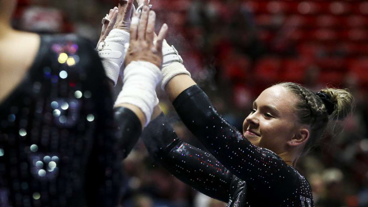 Utah gymnast Maile O'Keefe celebrates with teammates after competing on the uneven bars during the Red Rocks Preview gymnastics event at the Jon M. Huntsman Center on the University of Utah campus in Salt Lake City on Friday, Dec. 13, 2019.