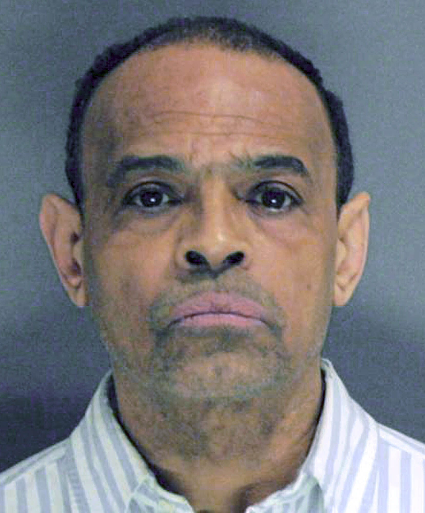 Imprisoned ex-school dean pleads not guilty to gang charge