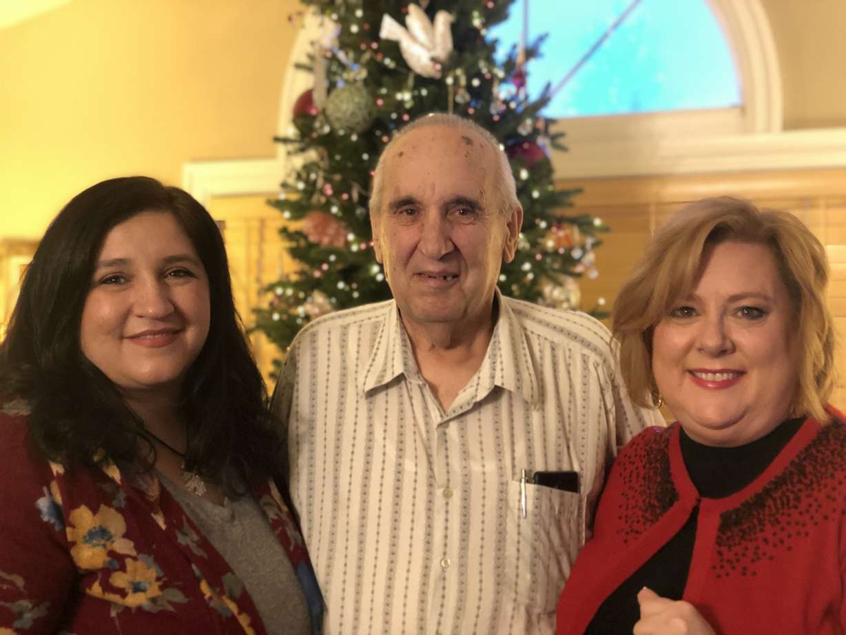 Juan Vasquez's sister, Alma Lake (left), his father, Stephen Bobowski (center), and his girlfriend, Emily Bingham (right), pose for a photo in the Bobowski home. (Photo: Liesl Nielsen, KSL.com)