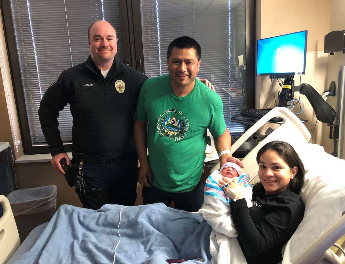 Officer Jeremy Dean visits with the parents of a new baby girl after helping deliver the baby on 3100 South on Tuesday, Feb. 11, 2020. (Photo: West Valley City Police Department)
