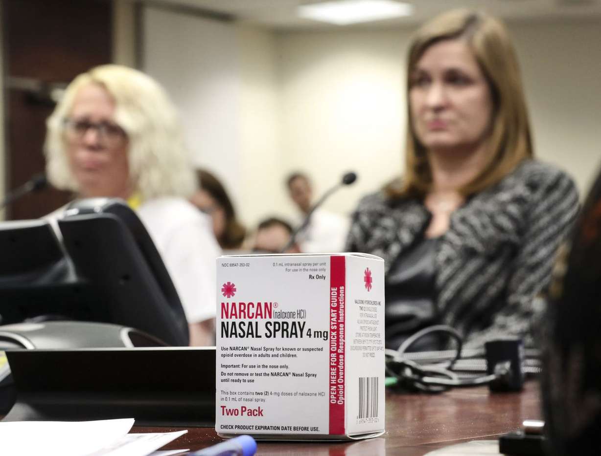 A nasal spray dose of naloxone — an antidote for opioid overdose — sits on a desk as Tiffani King, left, and Salt Lake County Mayor Jenny Wilson answer questions during a meeting at the Salt Lake County Government Center in Salt Lake City on Tuesday, Feb. 11, 2020, where the council and county employees learned how to use the drug. (Photo: Steve Griffin, KSL)