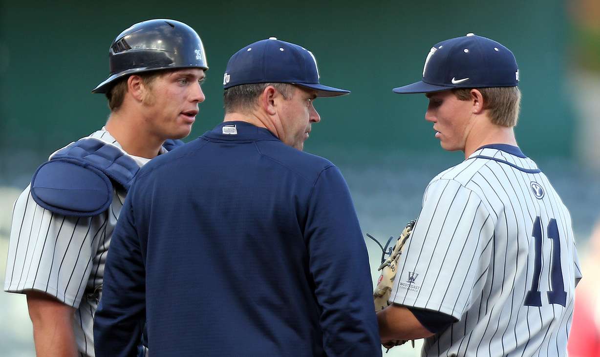 Brigham Young Cougars pitching coach Jeremy Thomas, center, talks with pitcher Easton Walker (11) during an NCAA baseball game against the Utah Utes at Smith's Ballpark in Salt Lake City Tuesday, May 17, 2016. (Photo: Chris Samuels, KSL, File)