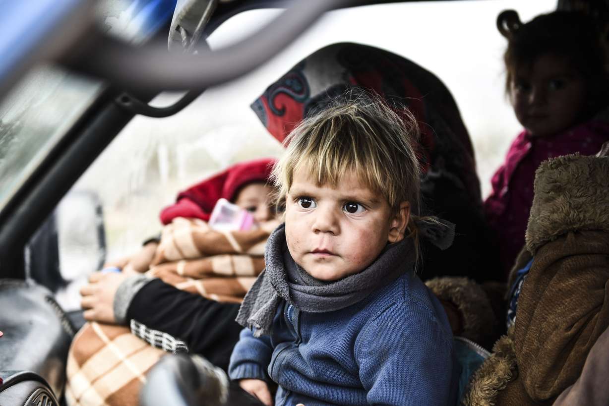 Syrian civilians flee from Idlib in rain toward the north to find safety inside Syria near the border with Turkey, Thursday, Feb. 13, 2020. Syrian troops are waging an offensive in the last rebel stronghold according to news reports by a Turkish news agency. (AP Photo)