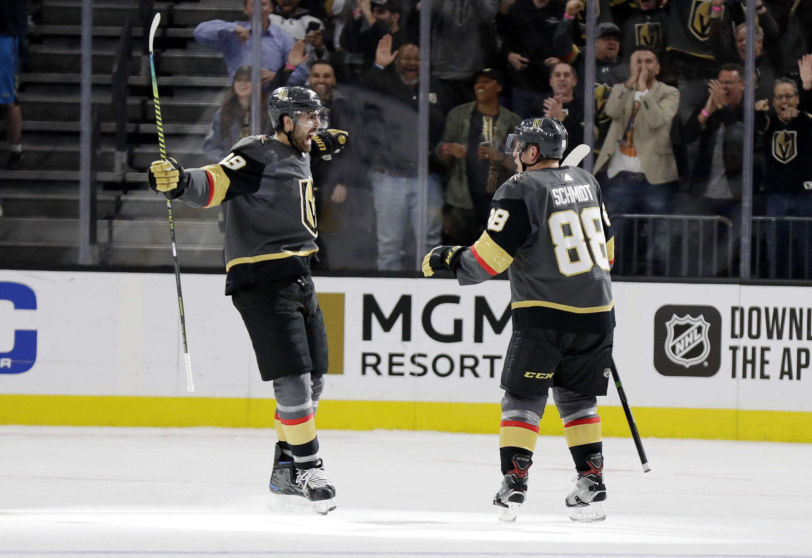 Vegas Golden Knights right wing Alex Tuch (89) and defenseman Nate Schmidt celebrate a Golden Knights score against the St. Louis Blues during the third period of an NHL hockey game Thursday, Feb. 13, 2020, in Las Vegas. Both players had goals in the period. The Golden Knights won 6-5 in overtime. (AP Photo/Isaac Brekken) [Feb-13-2020]
