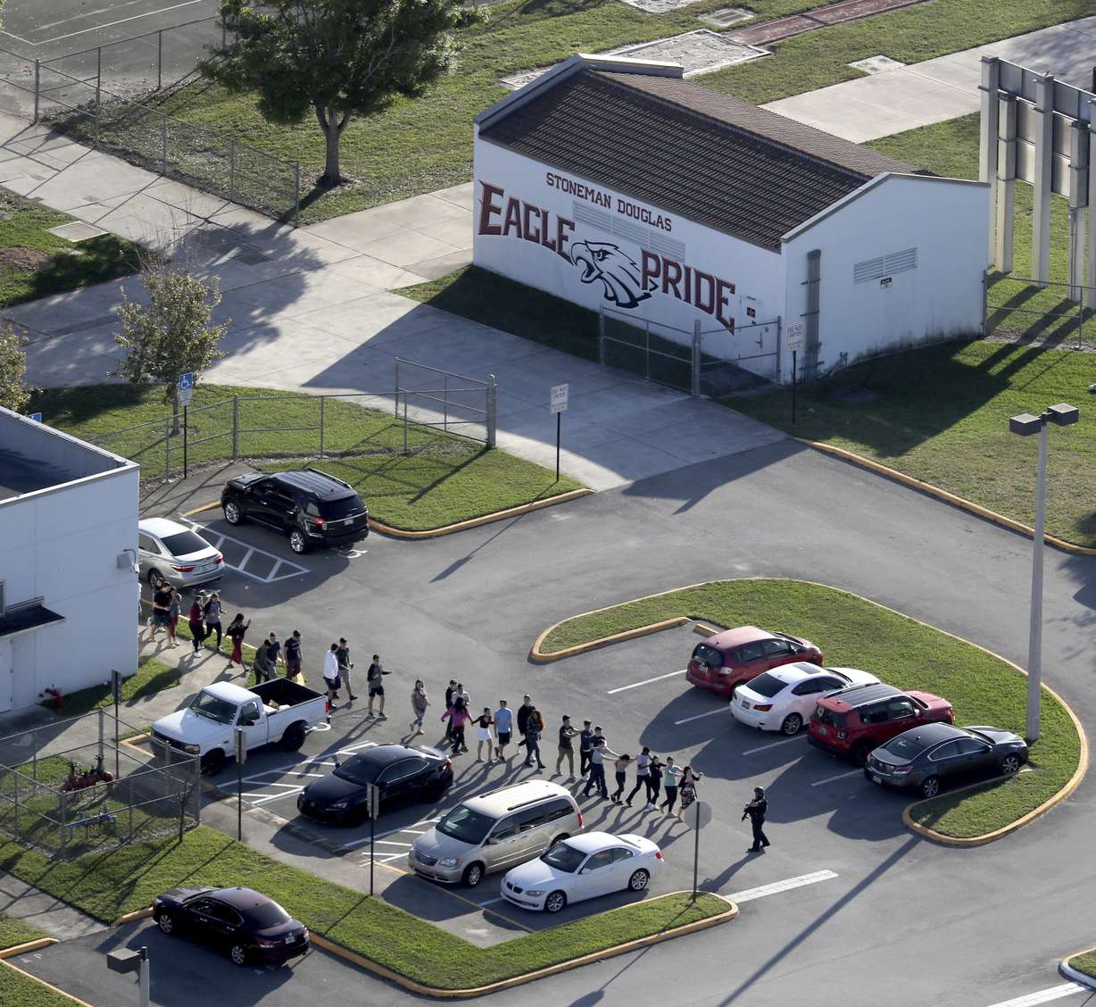 FILE - In this Wednesday, Feb. 14, 2018 file photo, students are evacuated by police from Marjory Stoneman Douglas High School in Parkland, Fla., after a shooter opened fire on the campus. Photo: AP Photo