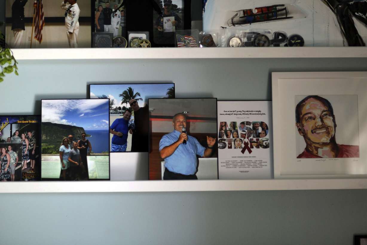 Memorabilia of Parkland school shooting victim Chris Hixon is displayed at his widow, Debbi Hixon's, home on the second anniversary of his death Friday, Feb. 14, 2020, in Hollywood, Fla. Hixon was one of 17 people killed in a school shooting on Valentine's Day two years ago at Marjory Stoneman Douglas High School. The home was recently renovated by the program "Military Makeovers." (AP Photo/Brynn Anderson)
